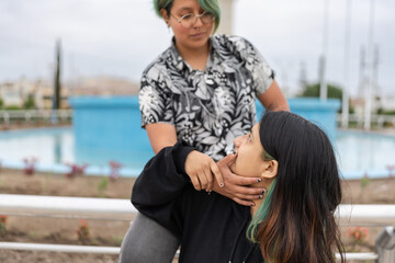 Cropped photo of a lesbian woman caressing her partner's face