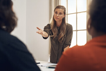 Young, upset and professional businesswoman in a meeting with two workers having an argument....