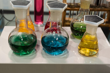 Spherical Glass Bottles Containing Liquids of Various Colors: Red, Green, Yellow and Blue