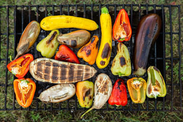 Fresh vegetables prepared on the grill outside. Tomatoes, sweet peppers, eggplant cooked outside.