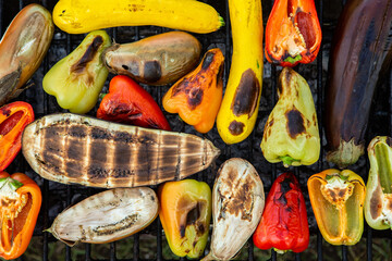 Fresh vegetables prepared on the grill outside. Tomatoes, sweet peppers, eggplant cooked outside.