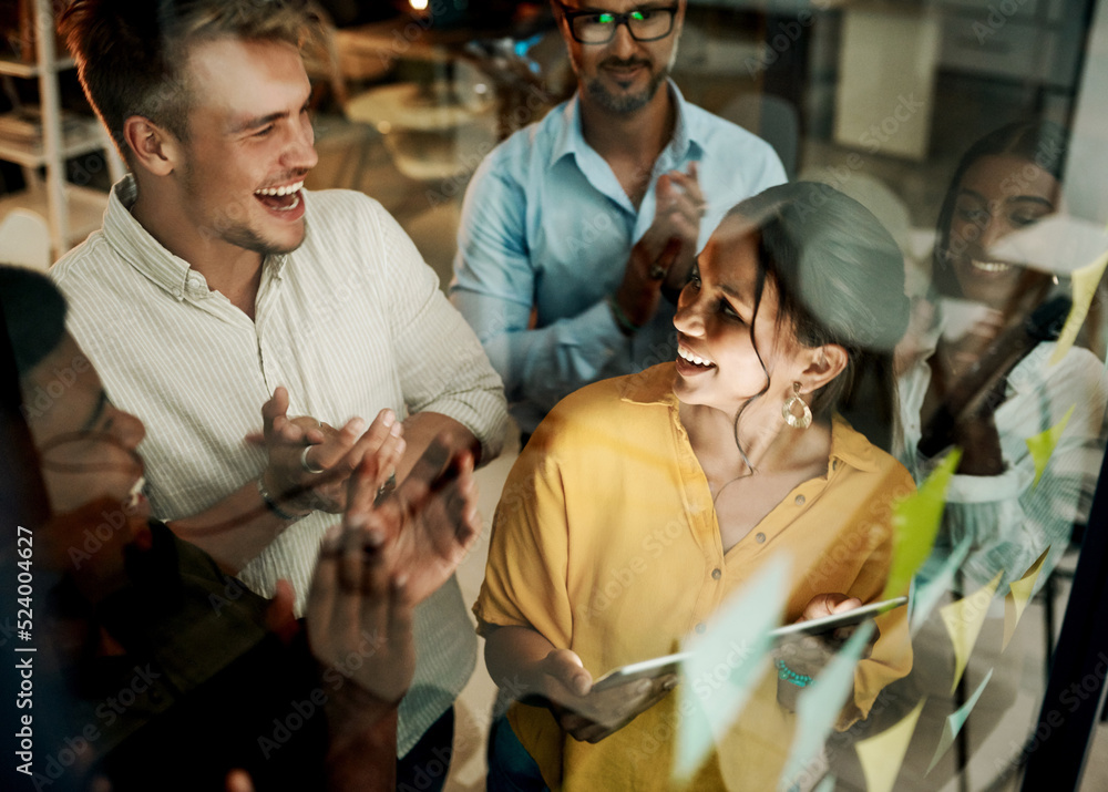 Poster successful business team clapping and cheering after planning a project on a glass wall in a office.