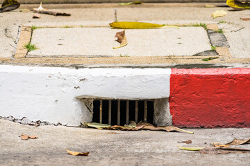 drainage system with rusty iron grating stormwater system road
