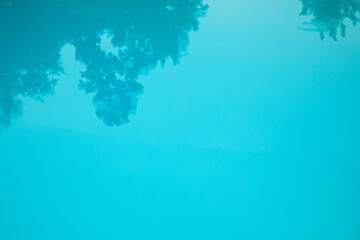 Fototapeta na wymiar Natural background, blue water in the pool with tree shadow