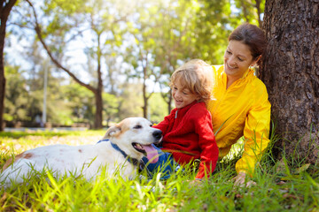 Family walking in autumn park. Fall fun.