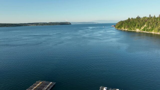 Aerial shot leaving the Penn Cove mussel farm docks and flying out into the bay.