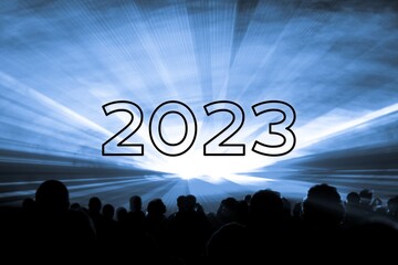 Happy new year 2023 blue laser show party people crowd. Luxury entertainment with audience silhouettes turn of the year celebration. Premium nightlife event at holidays season party time