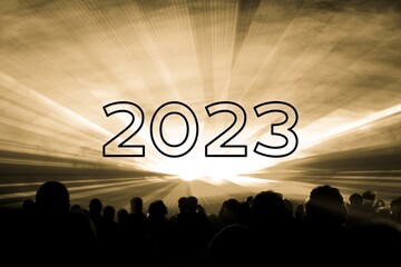 Happy new year 2023 yellow laser show party people crowd. Luxury entertainment with audience silhouettes turn of the year celebration. Premium nightlife event at holidays season party time