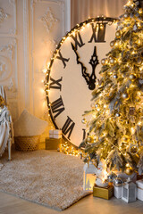 Vertical Photo of New Year's Location with Glowing Big Clock and Snow Covered Christmas Tree.