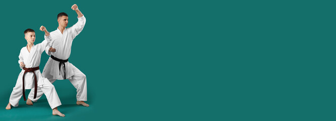 Boy practicing karate with instructor on green background. Banner for design