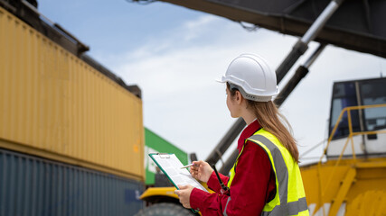 Woman inspector foreman Checking Cargo in Container cargo CustomTerminal port, Foerman use Clipboard paper for checking cargo concept  import export transportation and logistic insurance service