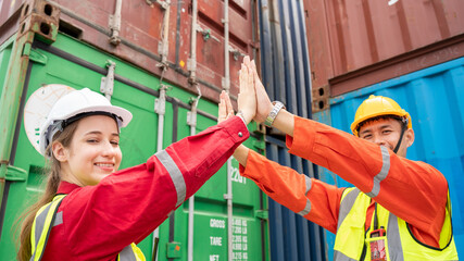 Success Woman manager and foreman Trust hand Hi Five hand after success project logistics business in front of Cargo concainer in warehouse , Manager in white helmet Safety Supervisor 