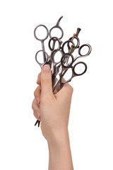 A woman's hand holds professional hairdressing scissors for cutting and thinning hair. Isolated on...