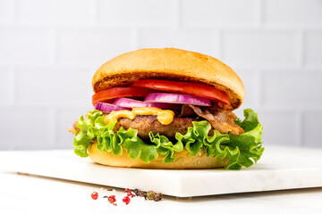 Hamburger with crispy bacon and potatoes fries 