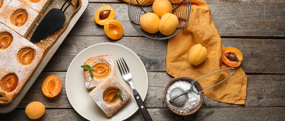 Composition with tasty apricot pie on wooden background, top view