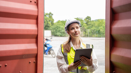 Woman Manager Using Tablet for checking code of Cargo container before import exprot concept logistics transportation shipping, Lady Foreman checking Cargo in warehouse terminal container port.