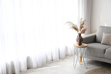 Interior of modern living room with sofa and table near window © Pixel-Shot
