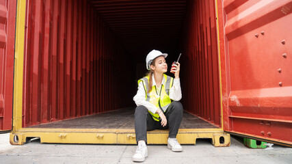 Woman foreman smile sit down inside of Cargo container in warehouse , Manager Safety Supervisor in Container Custom Terminal port concept import export