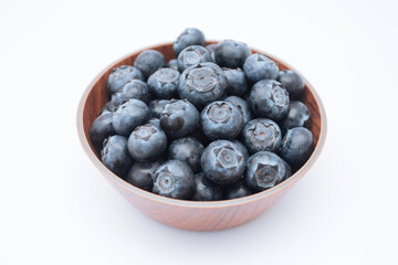 Blueberries in a bowl on white background