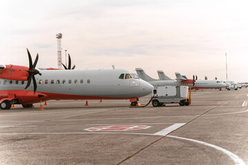 Fototapeta premium A lot of Airplanes standing in airport ready to flight
