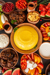 Homemade Romanian Food with polenta, meat, cheese and vegetables. Delicious corn porridge in clay dishes. Mamaliga or polenta, a traditional dish in Moldova, Hungary and Ukrainian cuisine.
