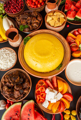 Homemade Romanian Food with polenta, meat, cheese and vegetables. Delicious corn porridge in clay dishes. Mamaliga or polenta, a traditional dish in Moldova, Hungary and Ukrainian cuisine.
