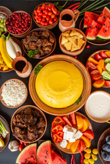 Homemade Romanian Food with polenta, meat, cheese and vegetables. Delicious corn porridge in clay dishes. Mamaliga or polenta, a traditional dish in Moldova, Hungary and Ukrainian cuisine.
