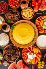 Homemade Romanian Food with polenta, meat, cheese and vegetables. Delicious corn porridge in clay dishes. Mamaliga or polenta, a traditional dish in Moldova, Hungary and Ukrainian cuisine.
