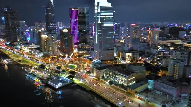 Aerial view of Bitexco Tower, buildings, roads, Thu Thiem 2 bridge and Saigon river in Ho Chi Minh city - Far away is Landmark 81 skyscraper. Travel concept.