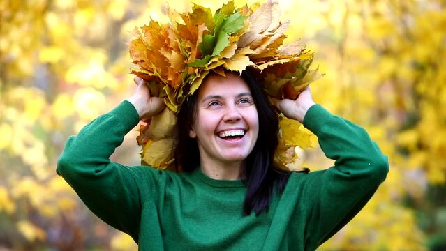 woman portrait put on maple leaves wreath