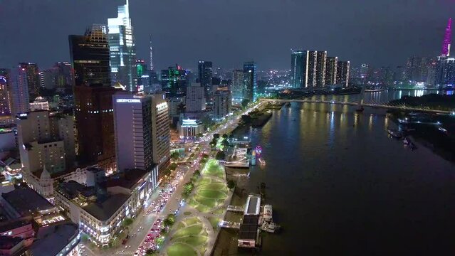 Aerial view of Bitexco Tower, buildings, roads, Thu Thiem 2 bridge and Saigon river in Ho Chi Minh city - Far away is Landmark 81 skyscraper. Travel concept.