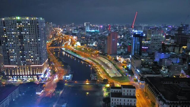 Aerial view of Bitexco Tower, buildings, roads, Thu Thiem 2 bridge and Saigon river in Ho Chi Minh city - Far away is Landmark 81 skyscraper. Travel concept.