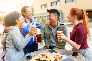 Cheerful friends drinking beer on street