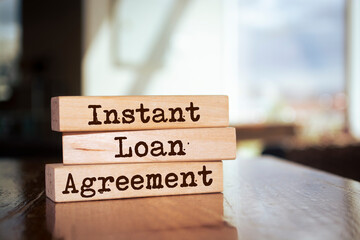 Wooden blocks with words 'Instant Loan Agreement'.