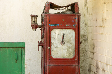 a old corroded red petrol pump