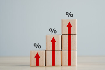 Interest rate finance and mortgage rates concept.  Wooden blocks with red arrow up and percentage...