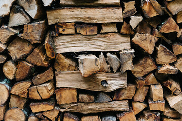 Dry chopped firewood logs. Wooden pile texture. Log background.