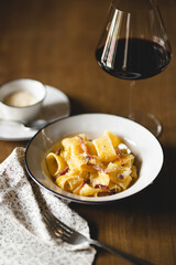 Restaurant serving pasta with parmesan and pepper. Food photography. Table setting.