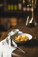 Restaurant serving pasta with parmesan and pepper. Food photography. Table setting.