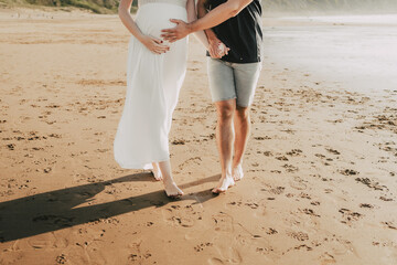 wedding couple sitting embraced on the beach
