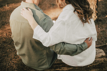 wedding couple sitting embraced on the beach