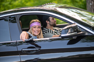 A couple in the car looking happy and cheerful