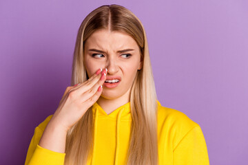 Photo of young woman hand near mouth frowning look empty space dislike isolated over violet color...
