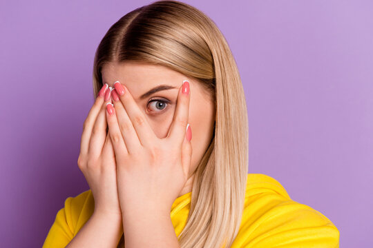 Photo of young woman cover face arms afraid worried frightened look eye isolated over violet color background