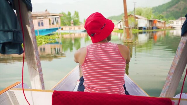 Beautiful view of Shikara boat ride on dal lake with houseboats background at Srinagar Kashmir, India.