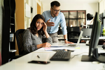  Colleagues arguing in office. Angry businessman yelling at his collegue