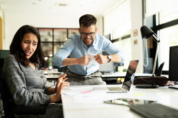  Colleagues arguing in office. Angry businessman yelling at his collegue