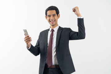 winner young asian businessman smiling and celebrating his success.