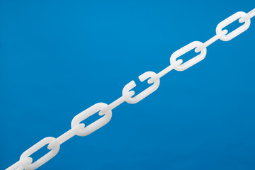 Fototapeta premium White plastic chain on blue background