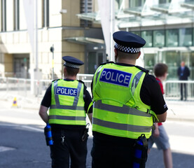 Police officer on duty on a city centre street during special event. 